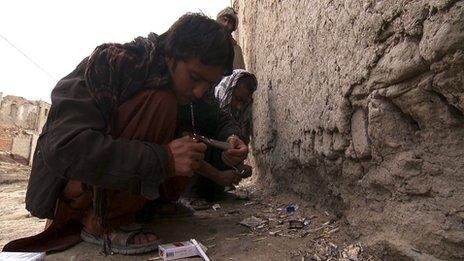Hashmat, 22, smokes opium on the streets of Kabul