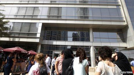 People wait outside after evacuating offices in Dubai Media City following earthquake tremors in Dubai April 16, 2013.