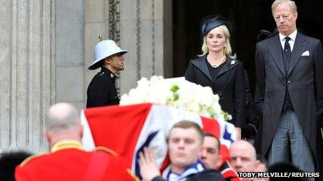 Mark Thatcher and his wife Sarah watch as the coffin of his mother is carried by military personnel outside St Paul's Cathedral after the funeral service