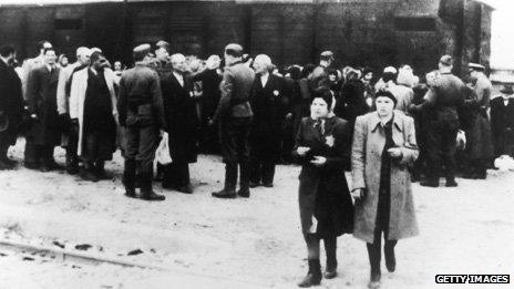 Newly arrived deportees and guards at the Nazi concentration camp at Auschwitz, Poland, circa 1943.