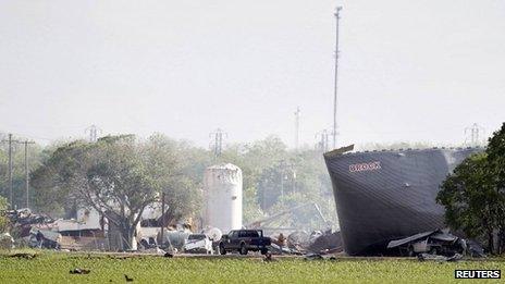 Workers are seen at the site of a fertilizer plant a day after a massive explosion in the town of West, near Waco