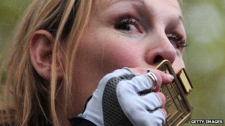 Claire Lomas kisses her medal after completing the London Marathon in 2012