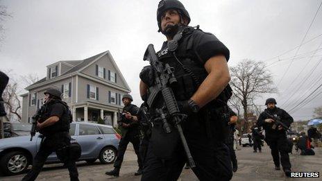 Police officers search house to house for Dzhokhar Tsarnaev, the surviving suspect in the Boston Marathon bombings, in a neighbourhood in Watertown, Massachusetts on Friday
