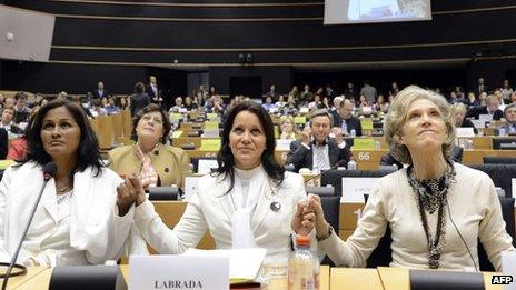 Three Cuban "Ladies in White", Laura Maria Labrada Pollan, Belkis Cantillo Ramirez and Elena Larrinaga hold hands at the European Parliament in Brussels