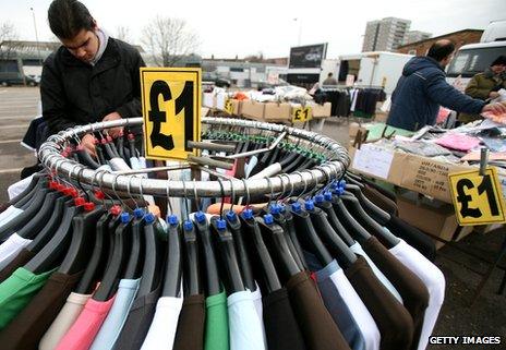A man looks at clothing on a rail at Wimbledon car boot sale and market in 2009