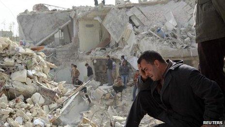 A Syrian man surveys damage caused by the conflict in Aleppo