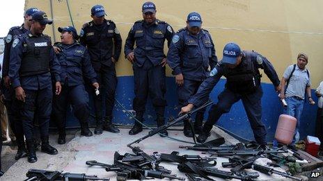 Police officers lay down their weapons during a work stoppage on 23 April 2013