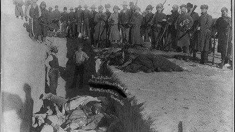 Burying the dead at a mass grave in Wounded Knee