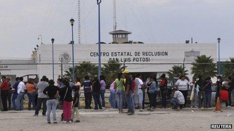 Relatives of inmates wait for information of their loved ones after inmates clashed at La Pila prison in San Luis Potosi on Saturday