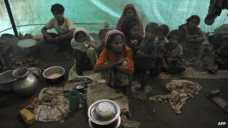 Muslim Rohingyas sitting inside their collective tent at the Dabang Internally Displaced Persons (IDP) camp