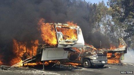 Recreational vehicles burn at the Springs Fire in the Camarillo Springs area of Ventura County, California on 2 May 2013