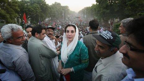 Benazir Bhutto poses for a photograph on the Pakistani Peoples Party bus on her welcome home parade on October 18, 2007