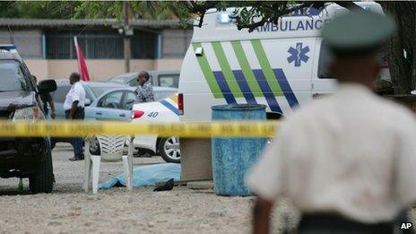 Forensic investigators examine the crime scene on 5 May 2013