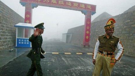 In this photograph taken on July 10, 2008, a Chinese soldier (L) and an Indian soldier stand guard at the Chinese side of the ancient Nathu La border crossing between India and China.