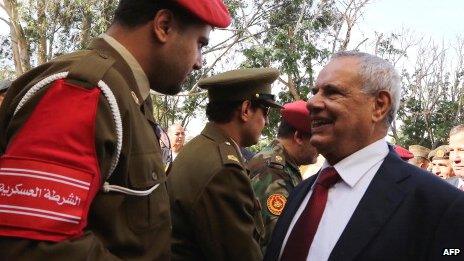 Libyan Defence Minister Mohammed al-Barghathi (R) shakes hand with a Libyan army officer - November 2012