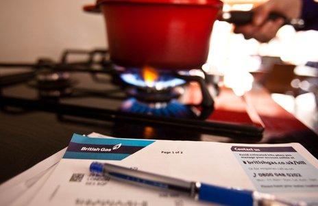 Generic image showing a gas bill next to a person cooking on a gas hob