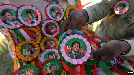 A Pakistani vendor arranges badges of Pakistani politician Imran Khan in Islamabad