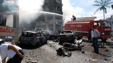 Firefighters douse smoking rubble after the blasts in Reyhanli, Turkey, 11 May