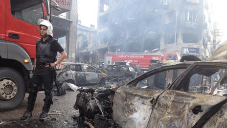A policeman stands at the blast site in Reyhanli, Turkey, 11 May