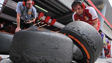 Mechanics examine tyre wear