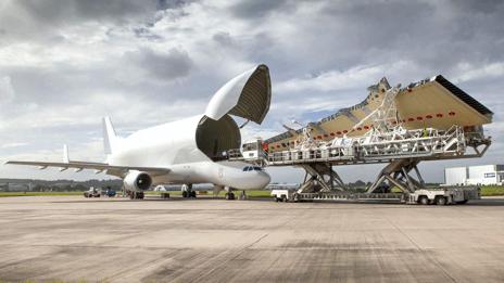 A Beluga opens its cargo bay door to transport a wing