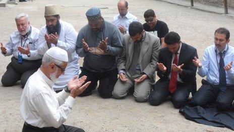 Muslims pray during a trip to Auschwitz
