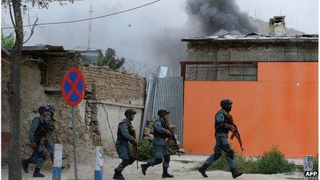 Afghan police run to the site of a gun battle, Kabul, 24 May 2013