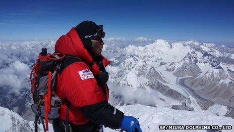 80-year-old Japanese man Yuichiro Miura stands atop the summit of Mount Everest (23 May 2013).