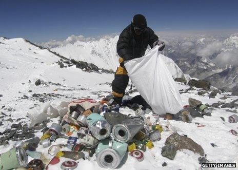 Sherpa collecting rubbish left by climbers in 2010