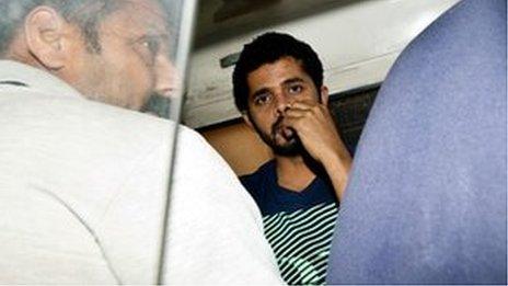 Indian cricketer Shanthakumaran Sreesanth sits in a police vehicle on his way to court in New Delhi on May 28, 2013.