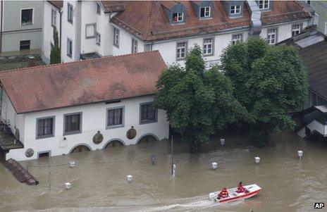 Rescue workers pass a flooded beer garden in Passau, Germany, 4 June