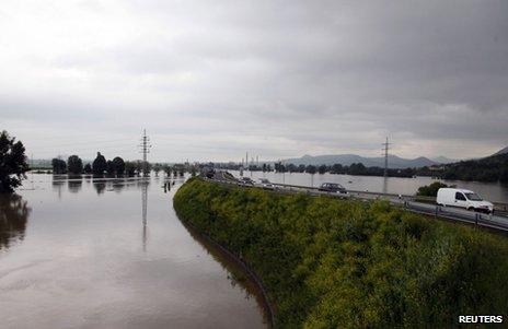 Traffic passes on a road surrounded by Elbe floodwater near Litomerice in the Czech Republic, 4 June