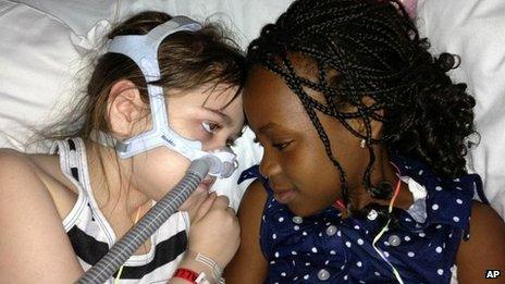Sarah Murnaghan, left, lies in her hospital bed next to adopted sister Ella on the 100th day of her stay in Children's Hospital of Philadelphia. 30 May 2013,