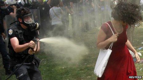 Turkish policeman spraying tear gas against a woman in Istanbul, 28 May 2013