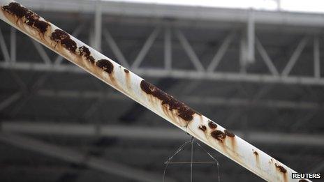 The remains of a kite hang on a badly conserved structure of the entrance of the Joao Havelange stadium