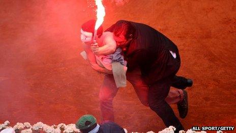 Security guard restrains flare-wielding protester, French Open, Paris (9 June)