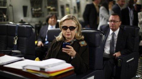 US Secretary of State Hillary Clinton checks her PDA upon departure in a military C-17 plane from Malta bound for Tripoli, 18 October 2011