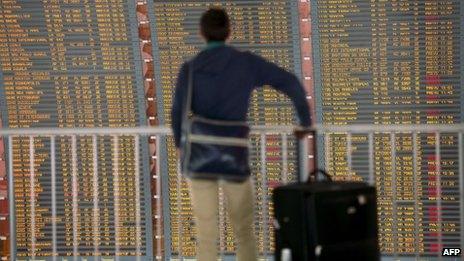 A passenger checks a board on 11 June 2013 at Roissy-Charles de Gaulle international airport