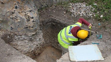 An archaeologist takes a measurement at the 12th Century Saffron Walden Castle