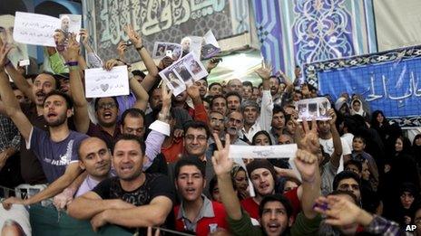 Supporters of Iranian President elect Hassan Rouhani, react, as he visits the shrine of the late revolutionary founder Ayatollah Khomeini, just outside Tehran