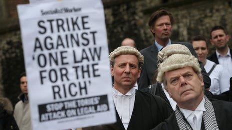 Lawyers listen to speeches near Parliament during a demonstration in support of Legal Aid on May 22, 2013 in London