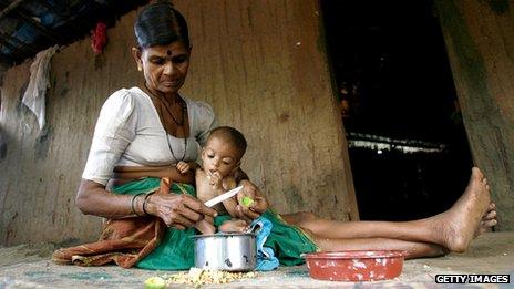 An Indian woman cares for her malnourished grandchild