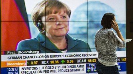 Merkel on screen in lobby of IMF building