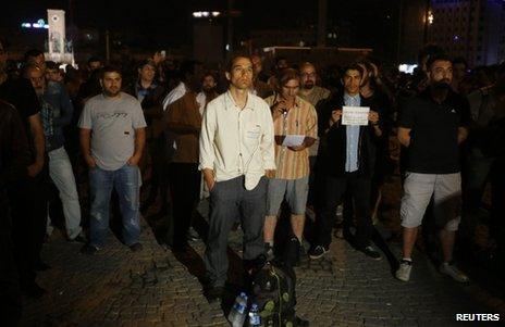 Erdem Gunduz (C) stands in a silent protest on Taksim Square in Istanbul, early on 18 June