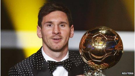 Lionel Messi smiles as he holds his FIFA Ballon d'Or trophy during Fifa's awards ceremony in Zurich, January 7 2013