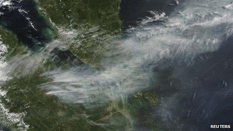 A Nasa satellite image shows smoke from forest fires in Sumatra blown eastwards to southern Malaysia and Singapore, 19 June 2013