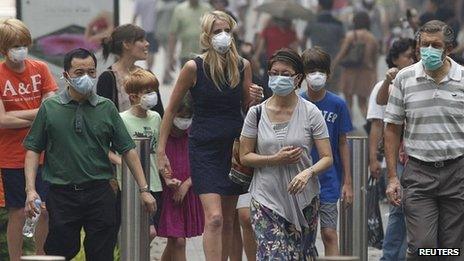 People in Singapore wear masks against the smog. 21 June 2013