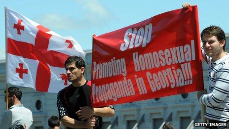 Two men in Georgia holding an anti-gay banner