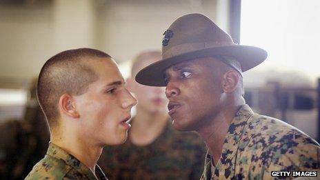 A drill sergeant stares at a marine
