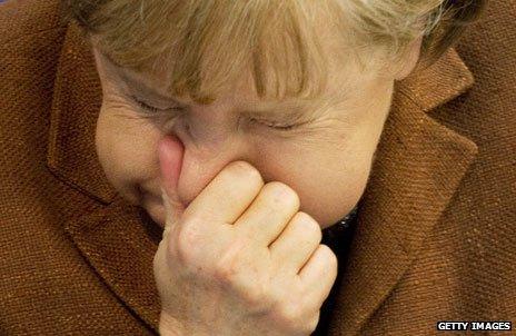 Angela Merkel sneezes
